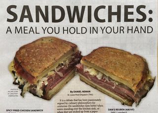 A newspaper headline reads “Sandwiches: A meal you hold in your hand” above an image of a corned beef reuben sliced in half.